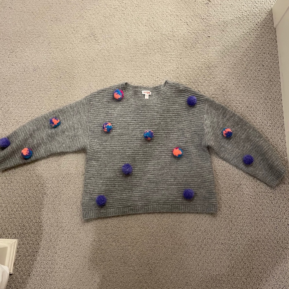 Cat and Jack grey sweater with Pom poms on it